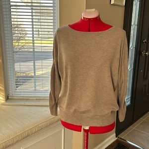 Oatmeal colored sweater with ruched sleeves.